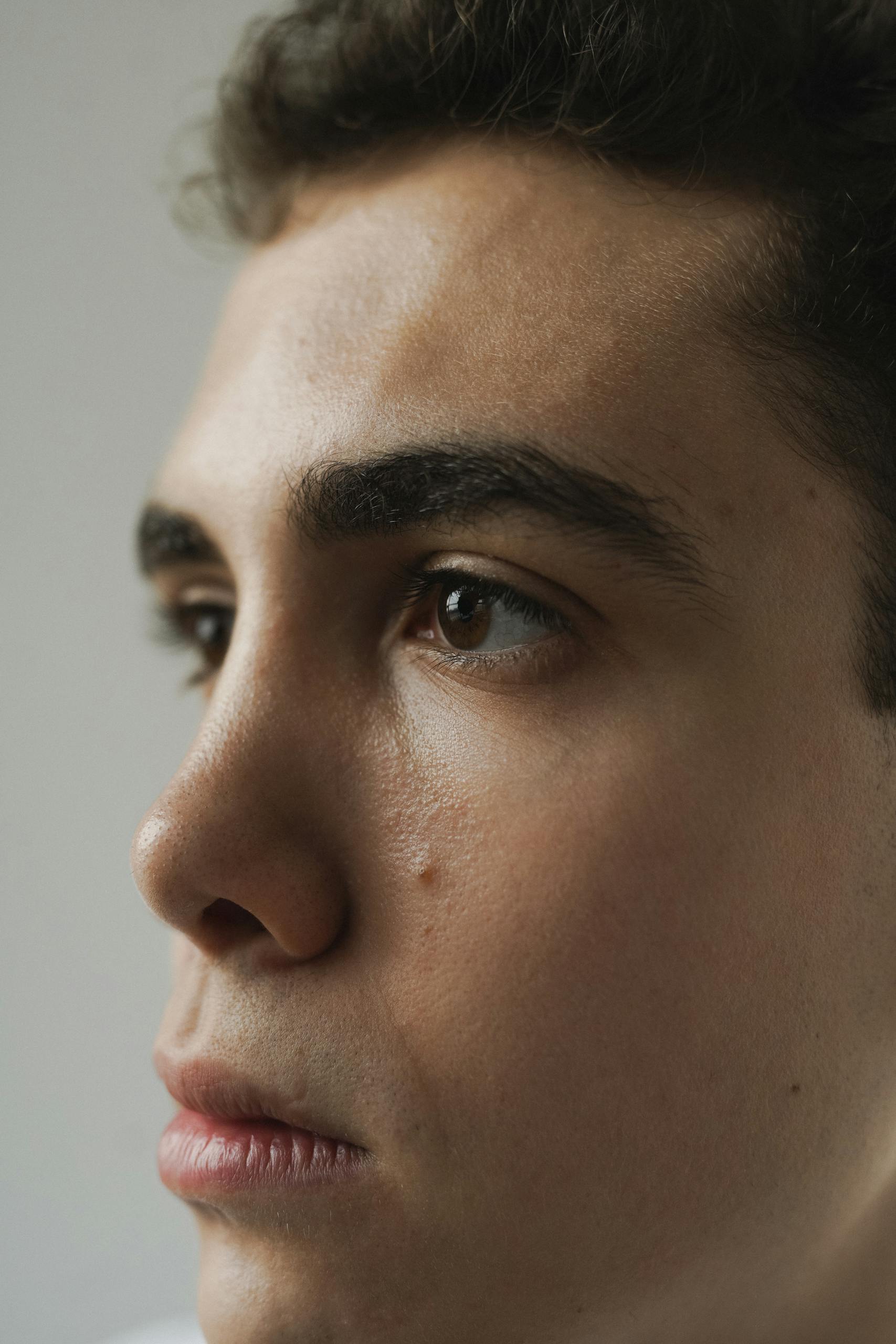 Detailed close-up of a young man with contemplative expression.